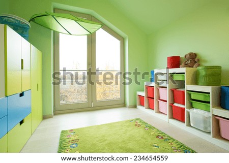 Cozy child\'s room with green painted walls