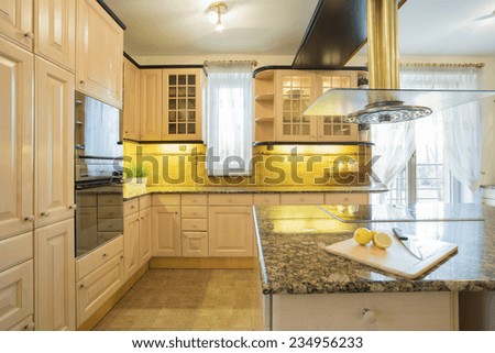 Horizontal view of beige furniture in  luxury kitchen