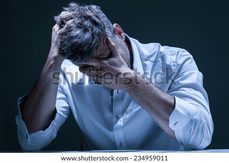 Portrait of young, depressed man in pain