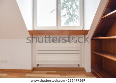 Radiator in cozy room with wooden elements