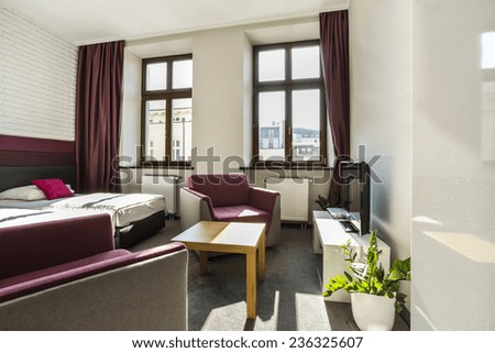 Modern,bright hotel room with violet theme
