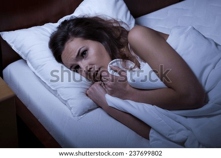 Image of scared woman trying to sleep
