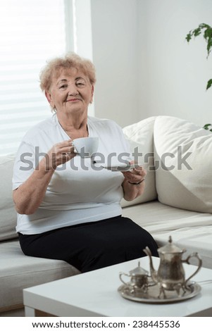 Elderly happy lady during her coffee time