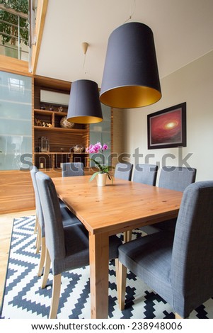 Image of eating room with wooden table and grey chairs