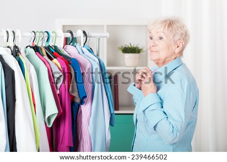 Older elegant lady dressing the shirt