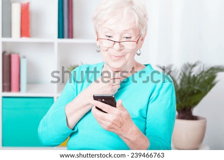Older smiled lady and her new smartphone