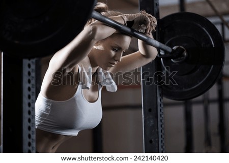 View of tired girl after weight lifting