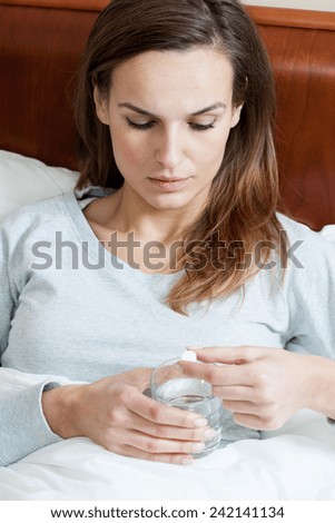 Woman in bed being sick during flu season