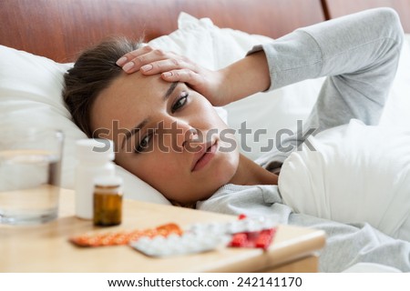 Horizontal view of ill woman feeling headache