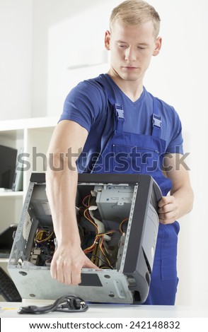 Young attractive man brings the broken computer