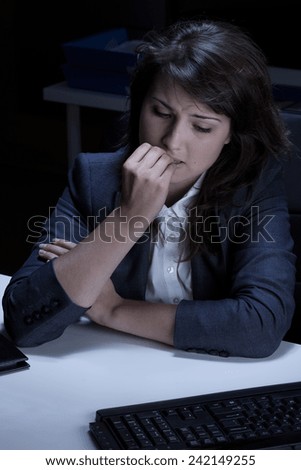 Stressed out and frustrated businesswoman biting her nails