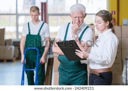 Image of manager talking with warehouse worker