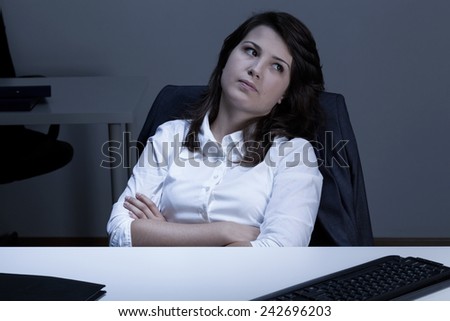Sad woman sitting at the desk in office