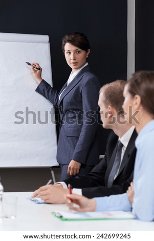 Woman presenting company data during business meeting