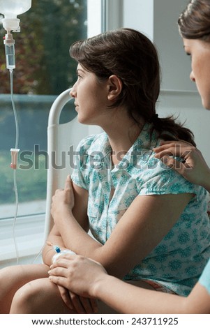 Nurse comforting a worried patient in hospital