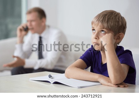 Close-up of bored child sitting at the desk
