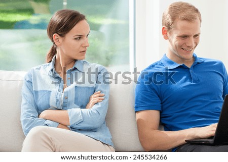 A woman angry with his husband for using his laptop