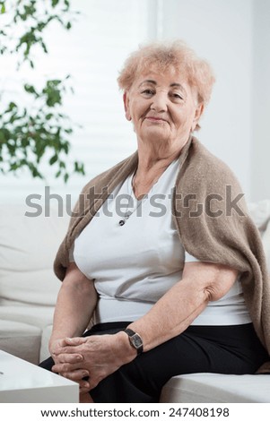 Smiling senior woman sitting on the couch