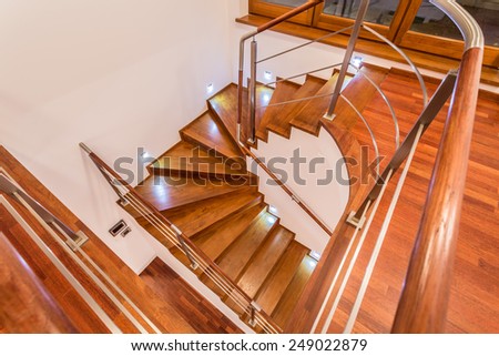 Close-up of winding wooden stairs in luxury mansion