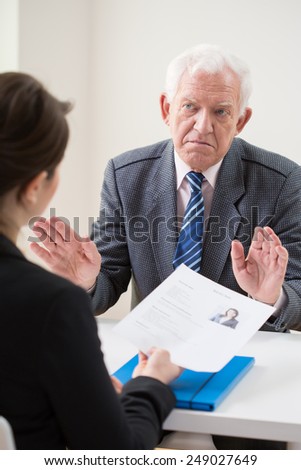Aged unhappy interviewer on job conversation