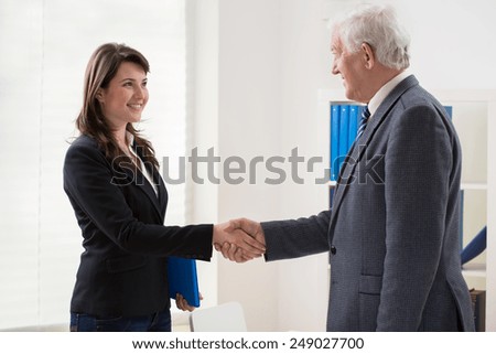 Young happy woman and her employer after interview
