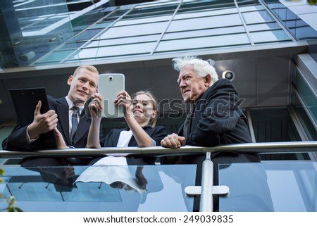 Image of office workers standing at the balcony