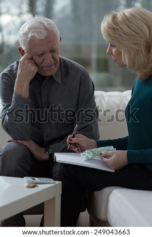 Elderly worried husband talking with his wife about budget