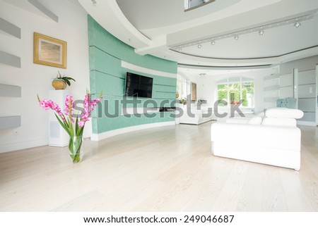 Vase with flowers standing on the parquet in salon