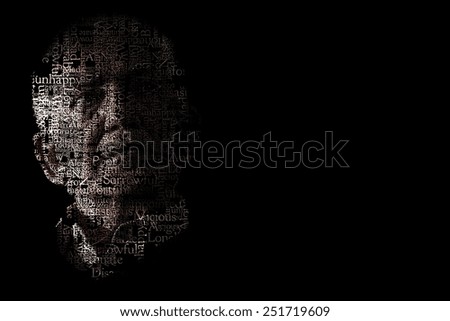 Artistic portrait of unhappy senior man on black background
