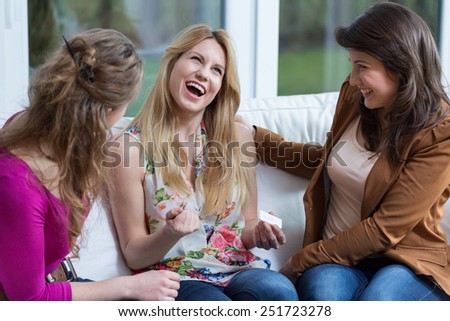 Young happy woman with positive pregnancy test