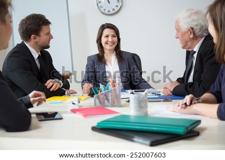 Young smiling businesswoman on funny business meeting