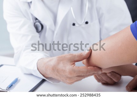 Experienced male doctor and physical examination of his patient