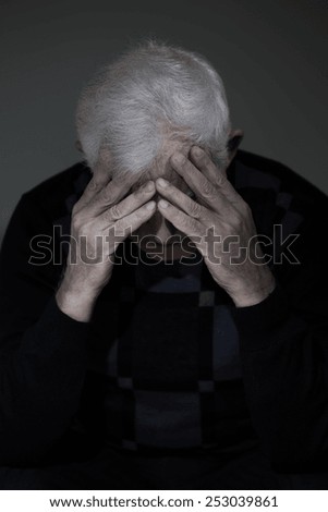 Widowed man mourning his lost love, vertical view
