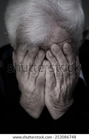 Portrait of old man with white hair crying