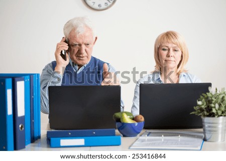 Two elderly people having their own company