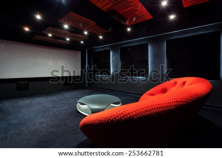 Comfortable red sofa in a dark interior