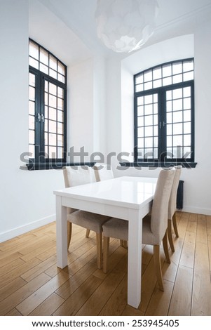 Bright dining area in loft space, vertical