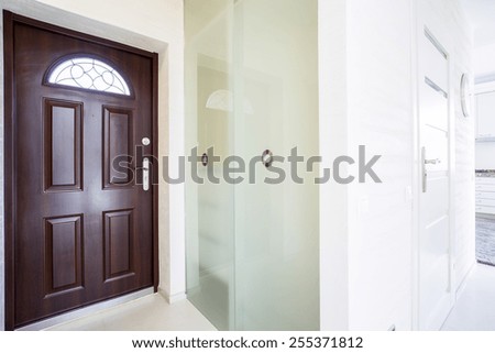 huge wooden entrance door inside modern apartment