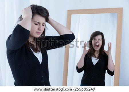 Young furious woman keeping her emotions inside her