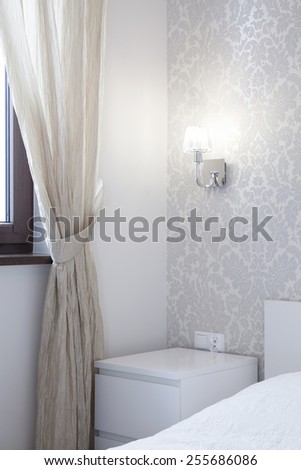 Vertical view of nightstand in romantic bedroom