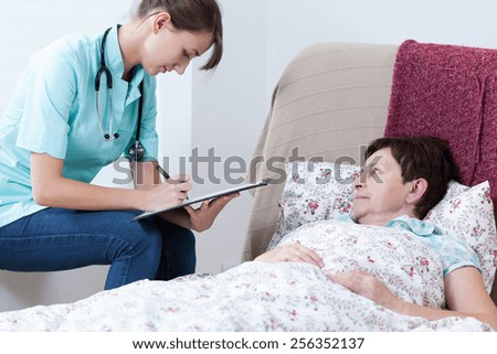 Physician doing medical interview at patient\'s home