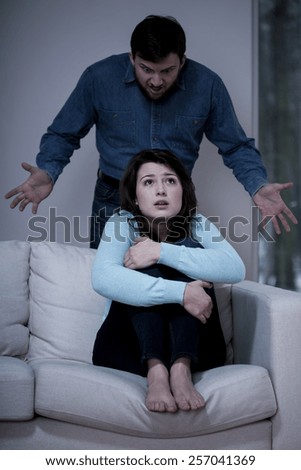 Young frightened woman listening to her husband\'s scream