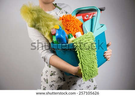 Close-up of woman holding bucket full of cleaners