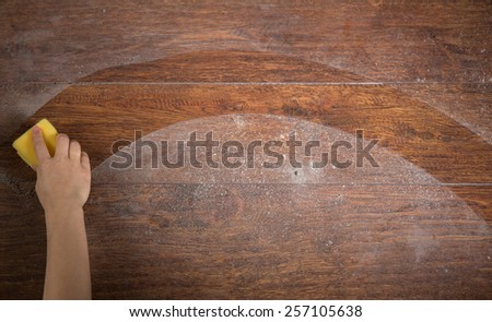 Photo of woman\'s hand cleaning the wooden floor