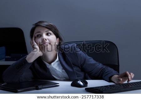 Bored female office worker sitting at the desk