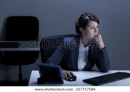 Woman working in the office at night
