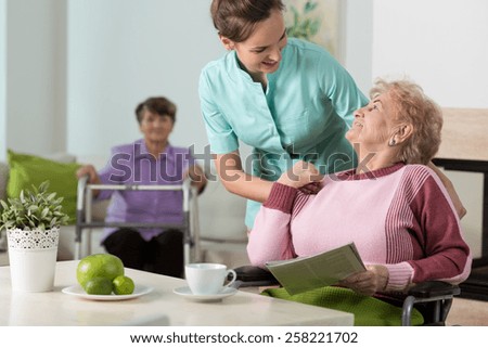 Helpful nurse working in old people\'s home