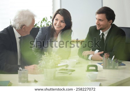 Three businesspeople during debate in conference room