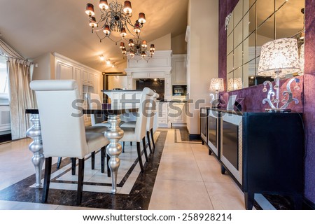Illuminated dining room interior in luxury mansion