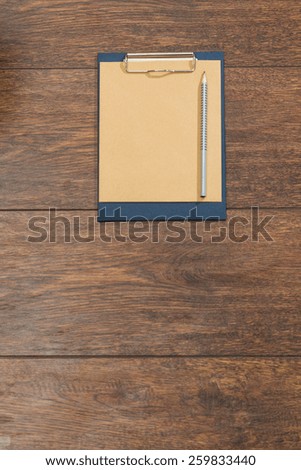 Close-up of blank clipboard on wooden desk